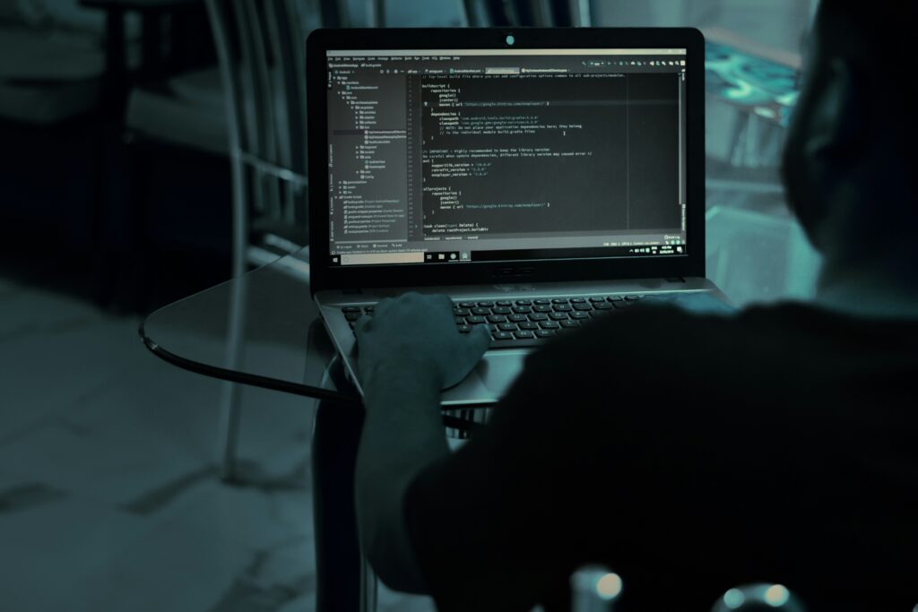 Almeida law group | man in a dark room coding at his laptop